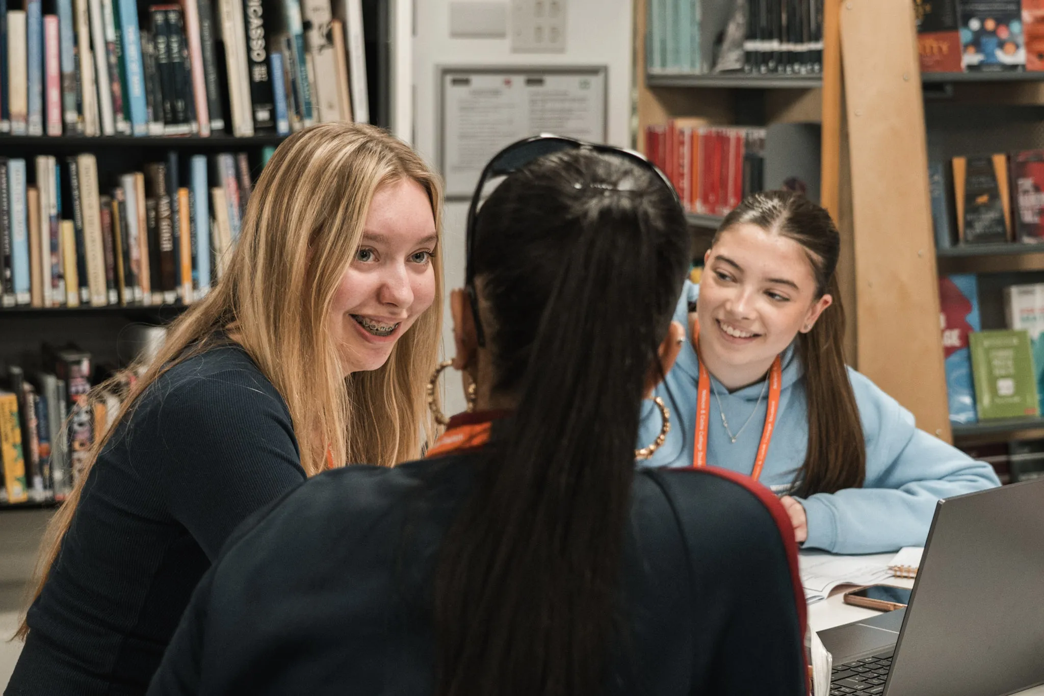 Three students smiling