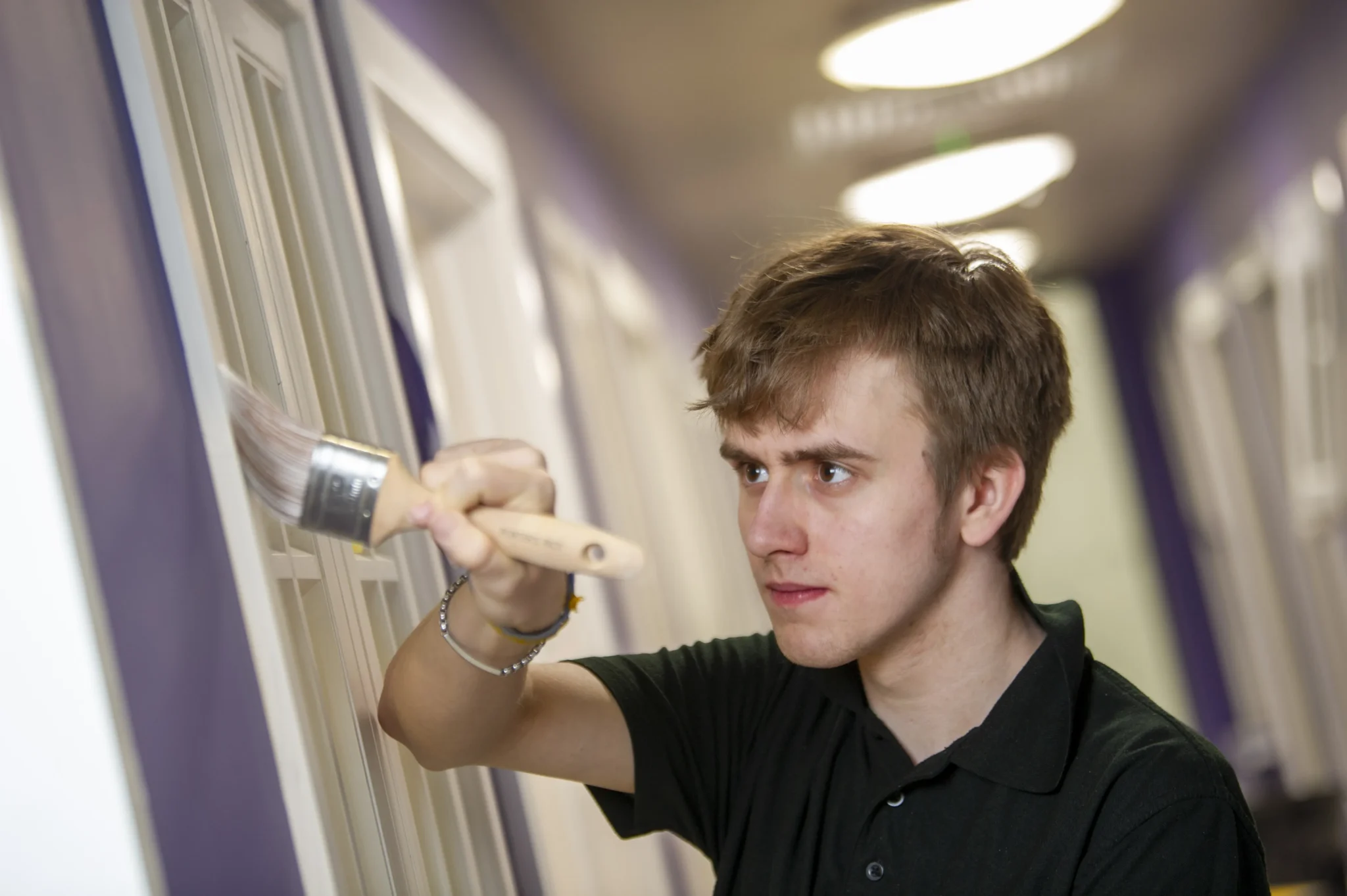 Student painting on a wall